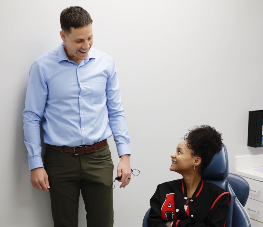 doctor smiling with teen patient